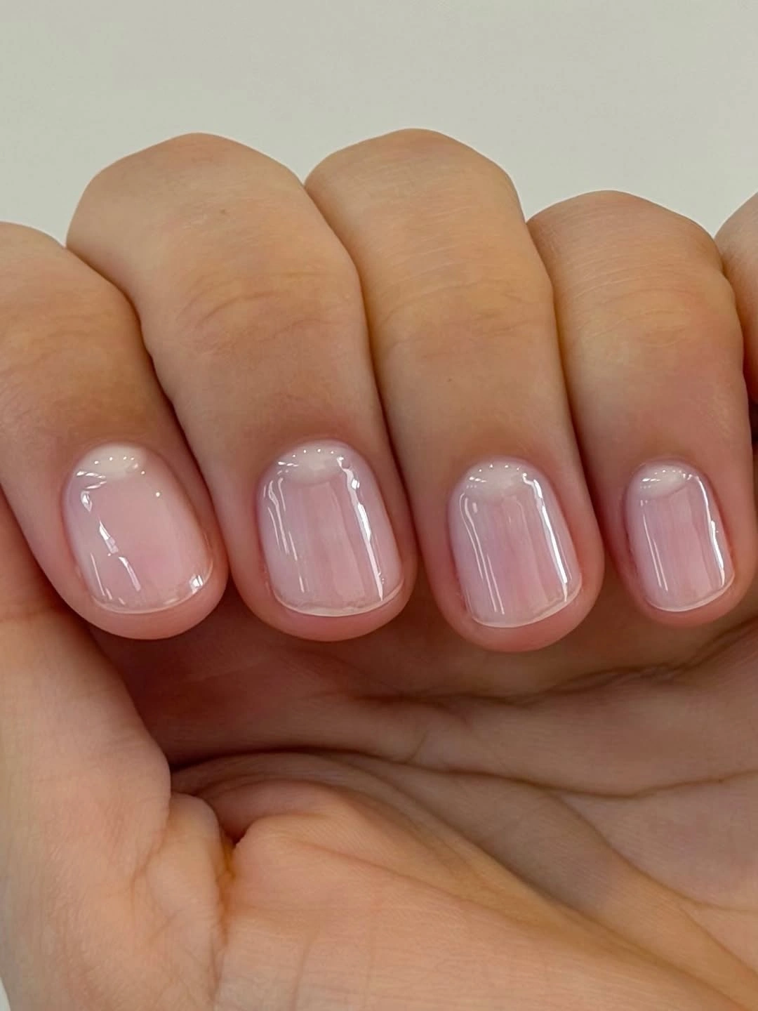 Very short nails with sheer milky pink gloss