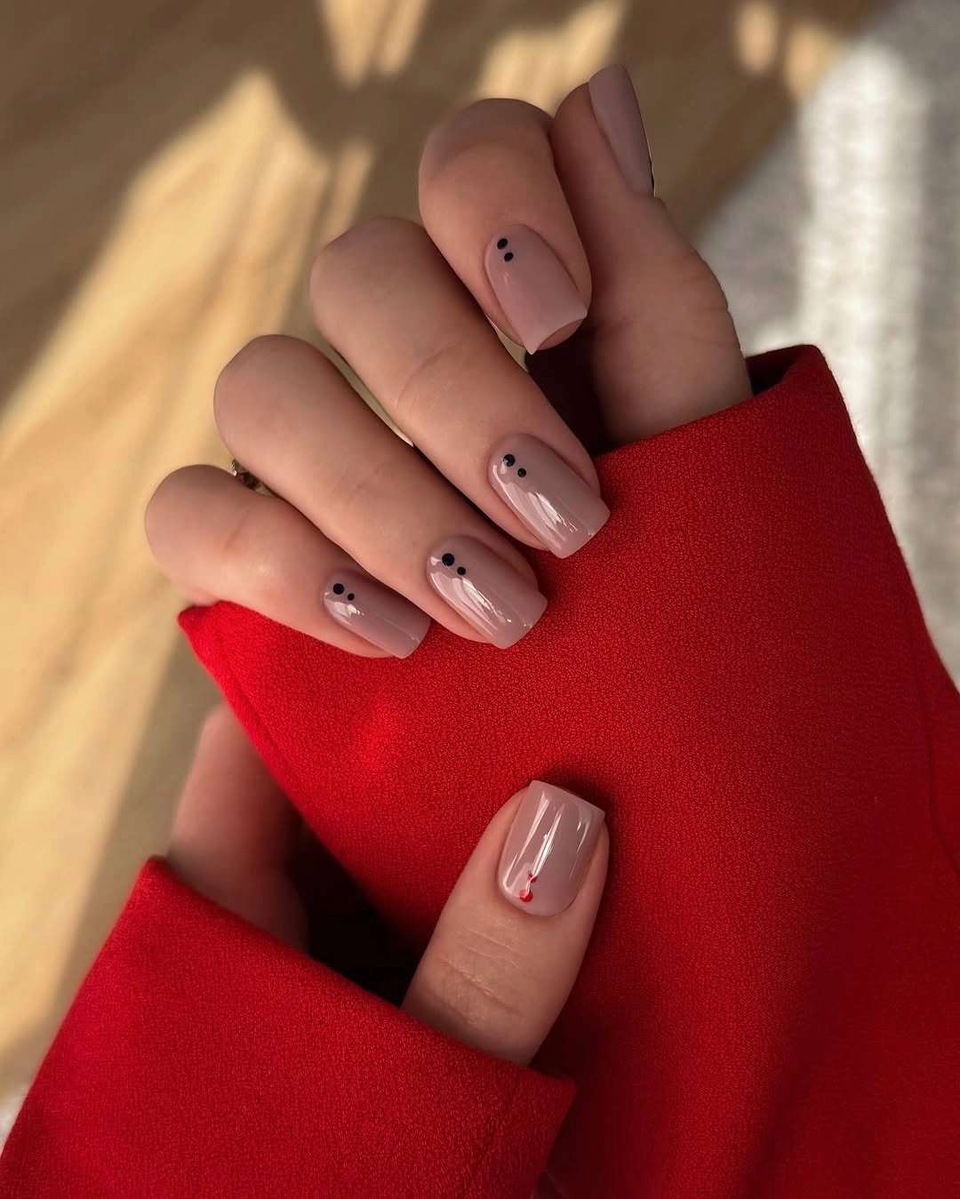 Beige short square nails with tiny black dot accents