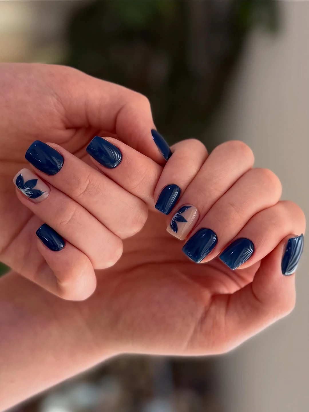 Navy short nails with pale blue brushstroke accents