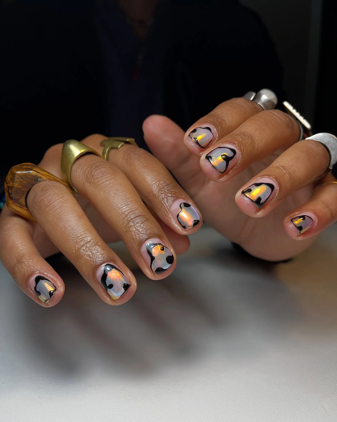 Natural short nails with black dots and amber accents