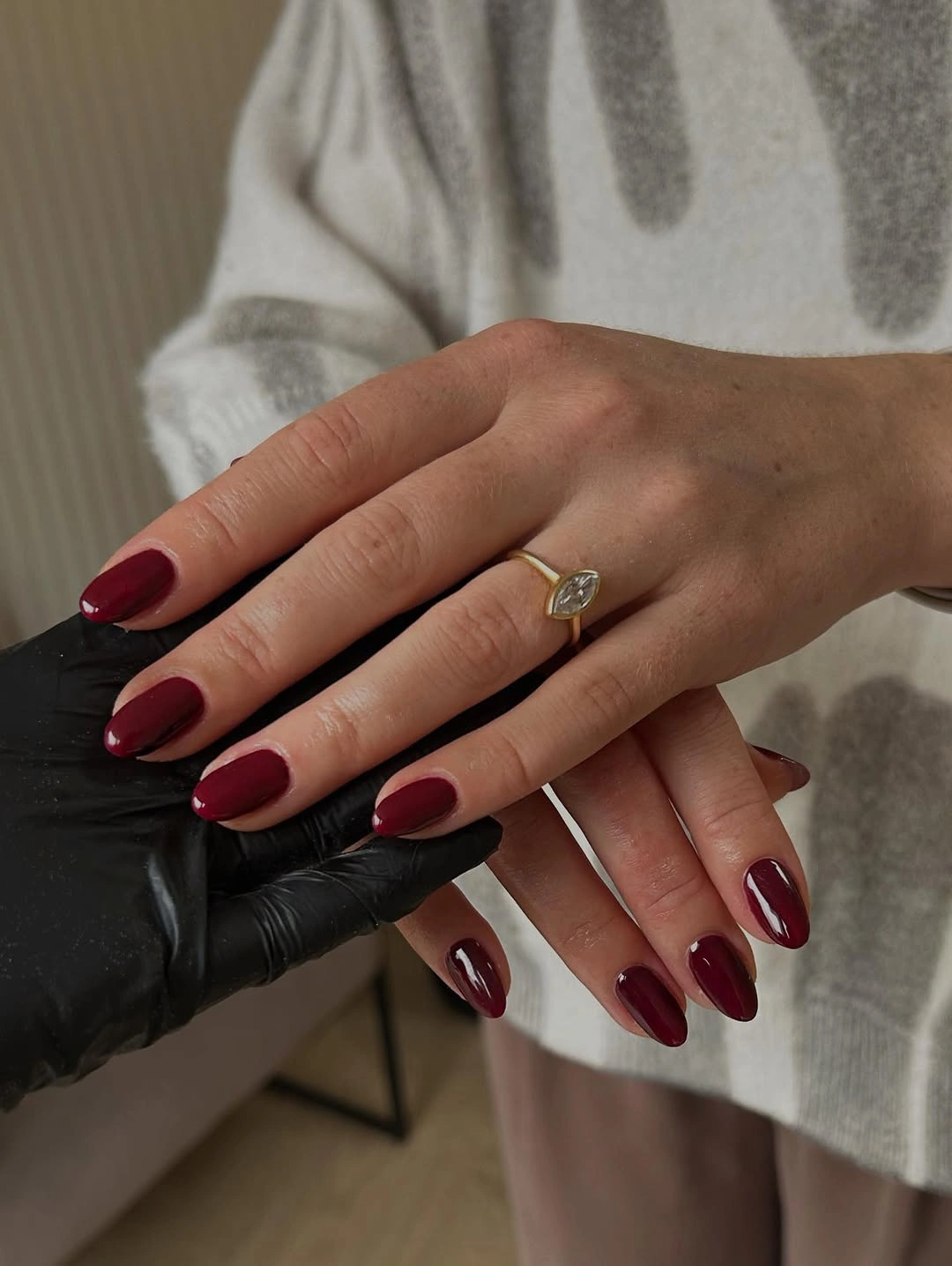 Medium almond nails in glossy burgundy polish