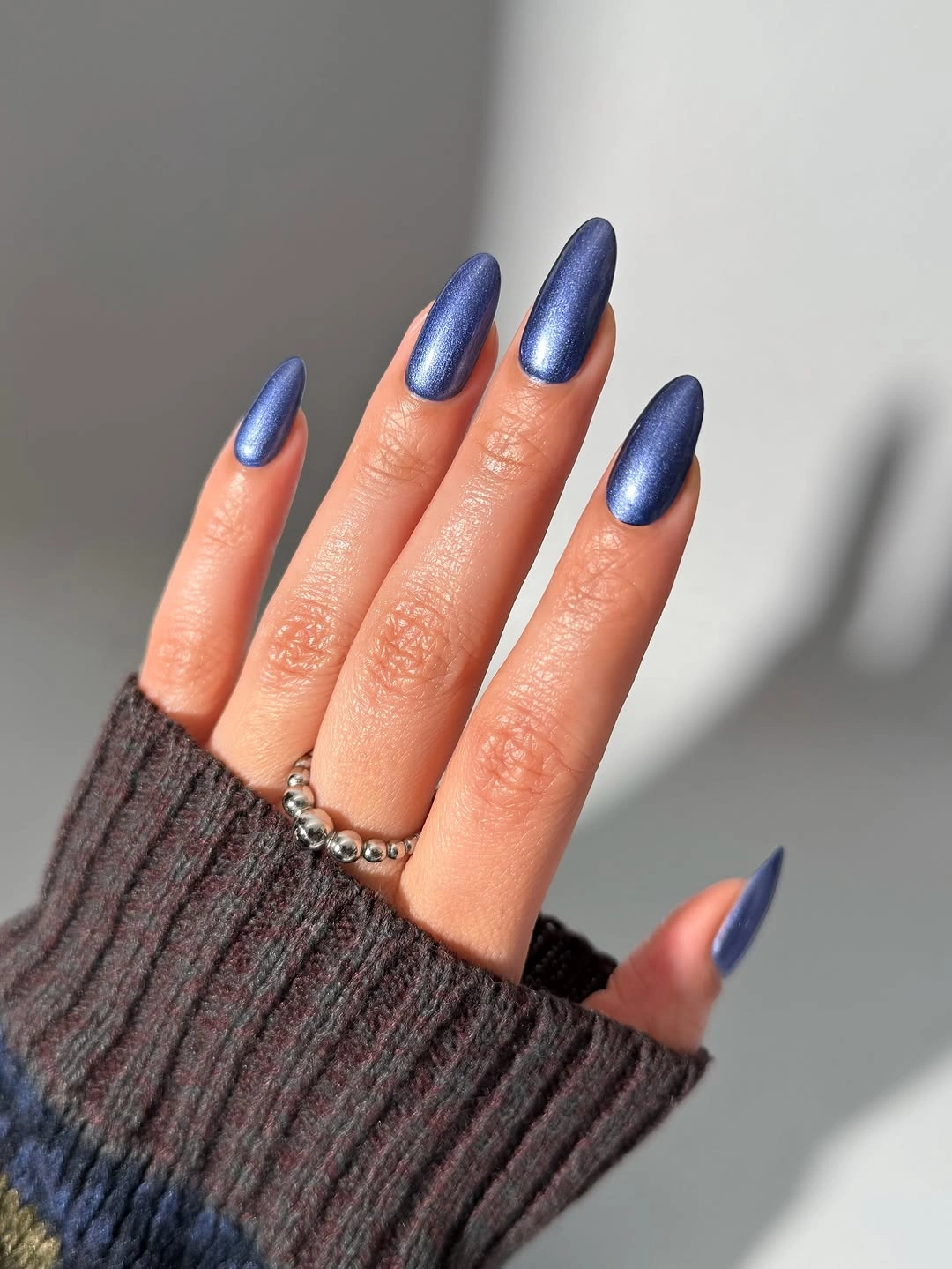 Long almond nails in satin metallic blue polish