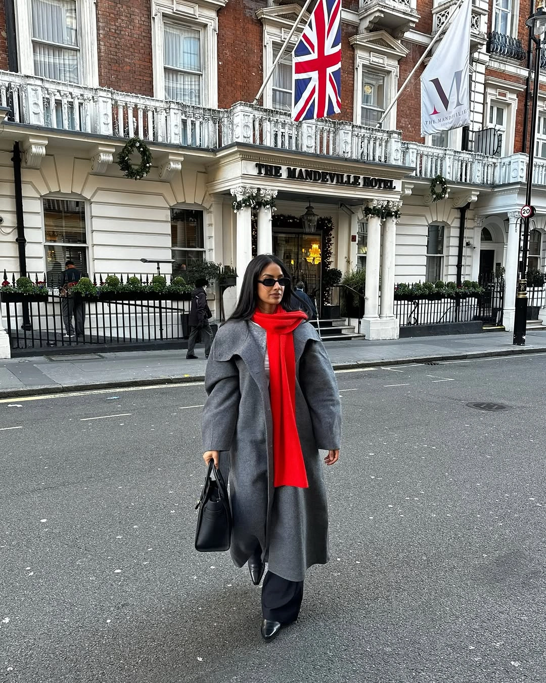 Gray coat with red scarf, black trousers and pointed boots