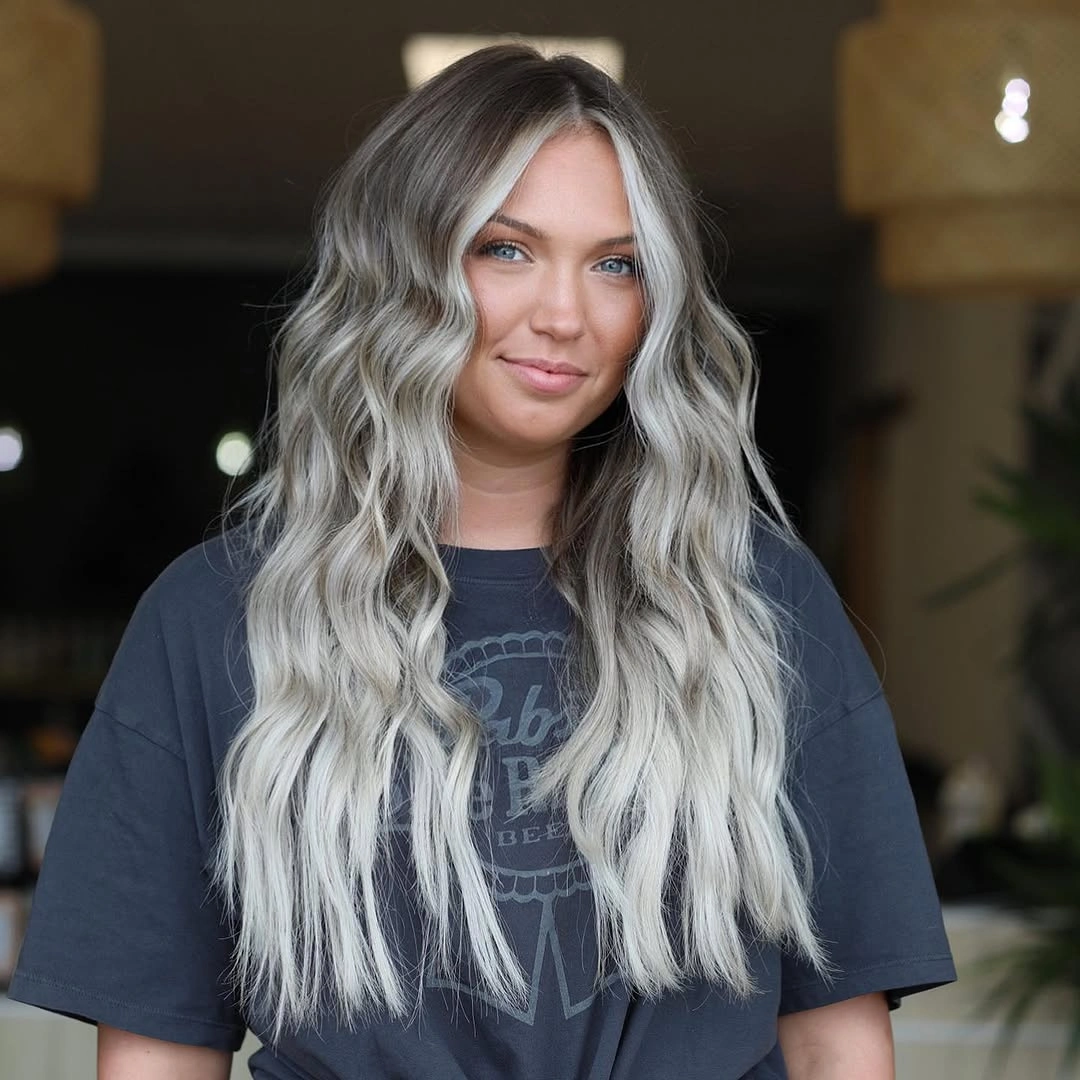 Long silver blonde waves with dark root shadow