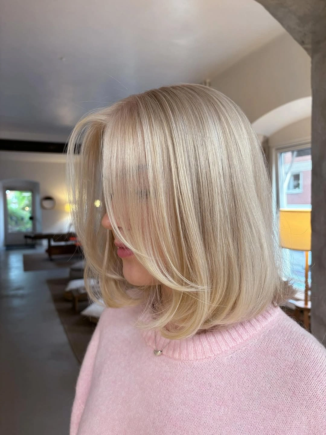 Smooth pale blonde bob with side-swept front layer