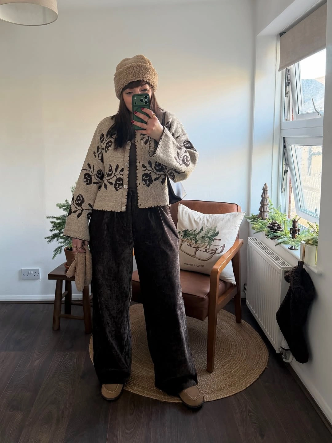 Cream patterned cardigan with dark wide trousers and beanie