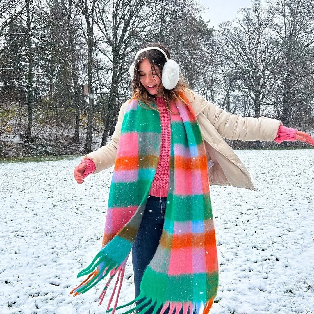 Cream coat with multicolor scarf, dark pants and pink gloves