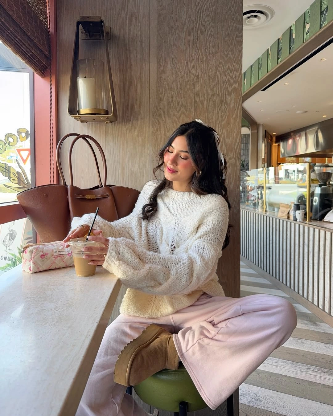 Fuzzy cream sweater with pale pink trousers and tan boots
