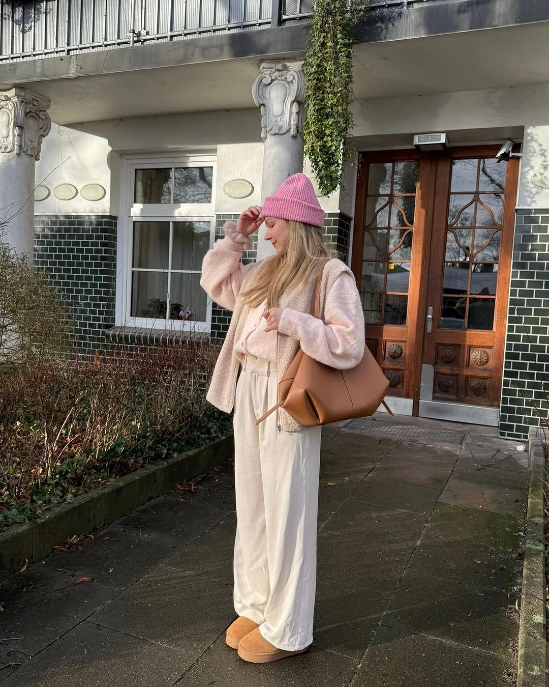 Cream puffer outfit with pink beanie and tan accessories