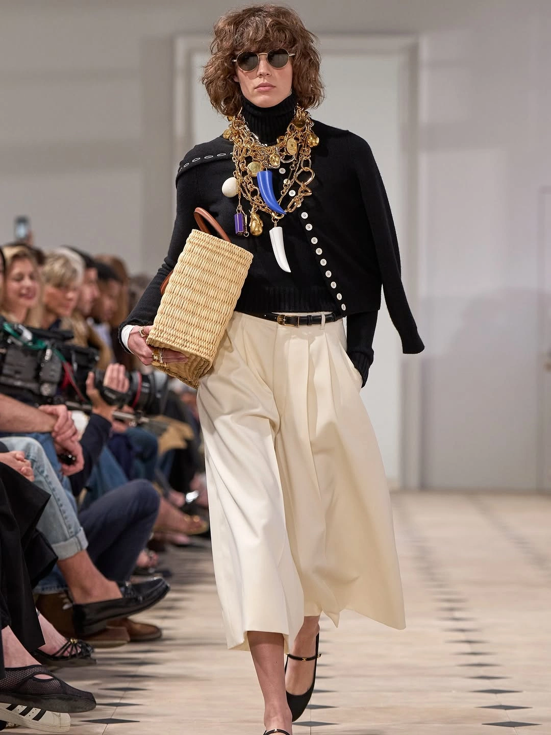 Black top white pleated skirt and layered gold jewelry