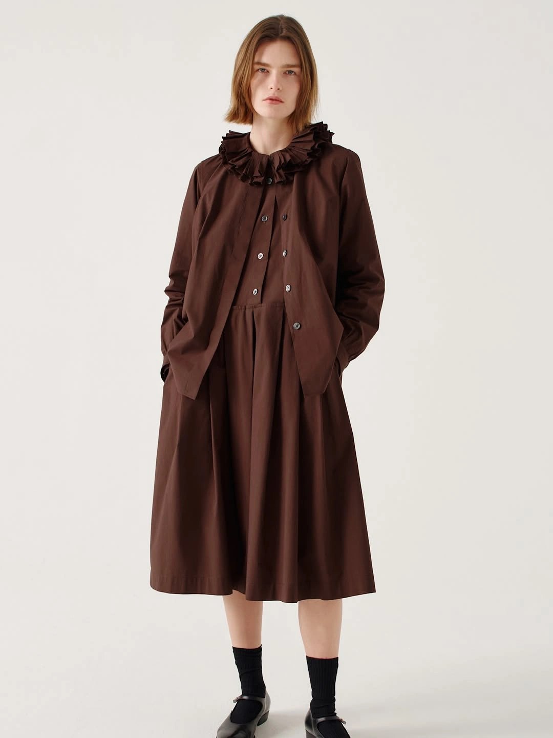 Long brown dress with ruffled collar and black Mary Janes