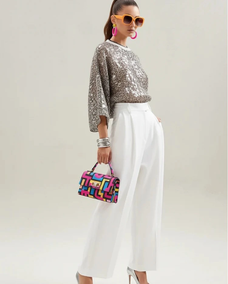 Silver sequined top with white trousers and colorful accessories