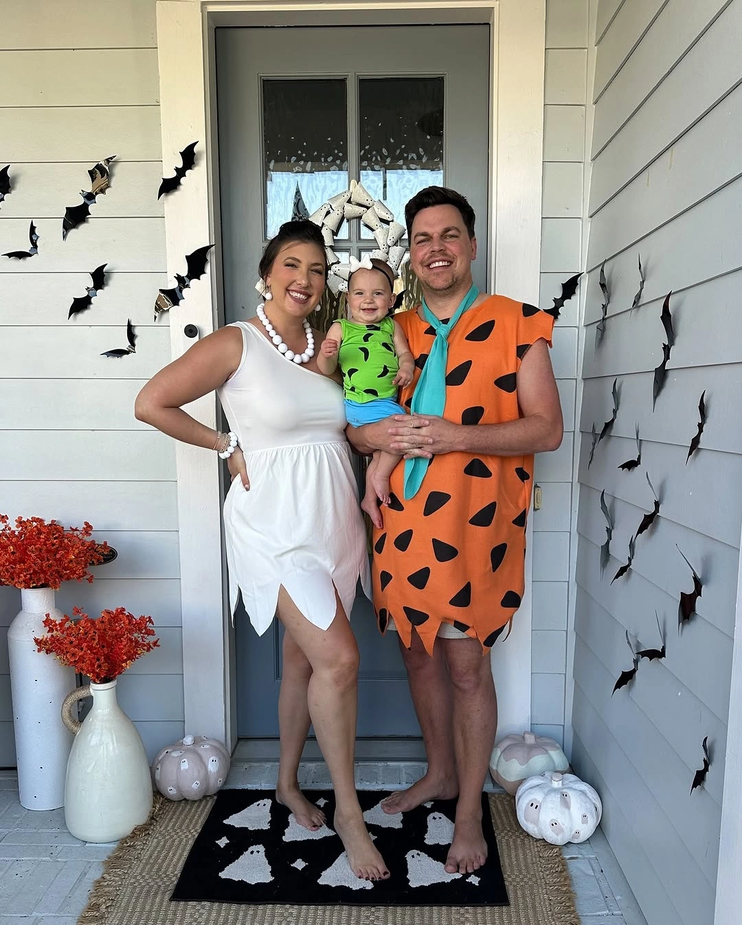 Orange patterned adult costume beside white dress and child look