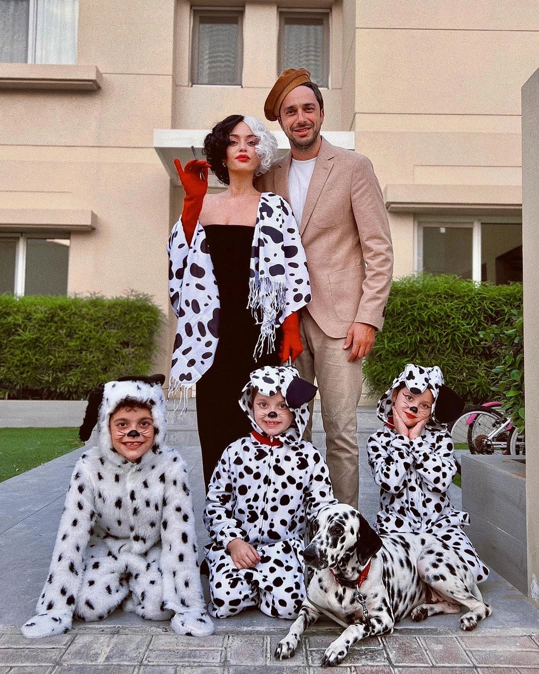 Red and black family Halloween costumes with dog accent