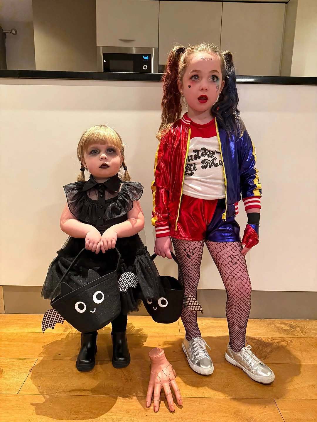 Contrasting black and red-blue costumes for two girls