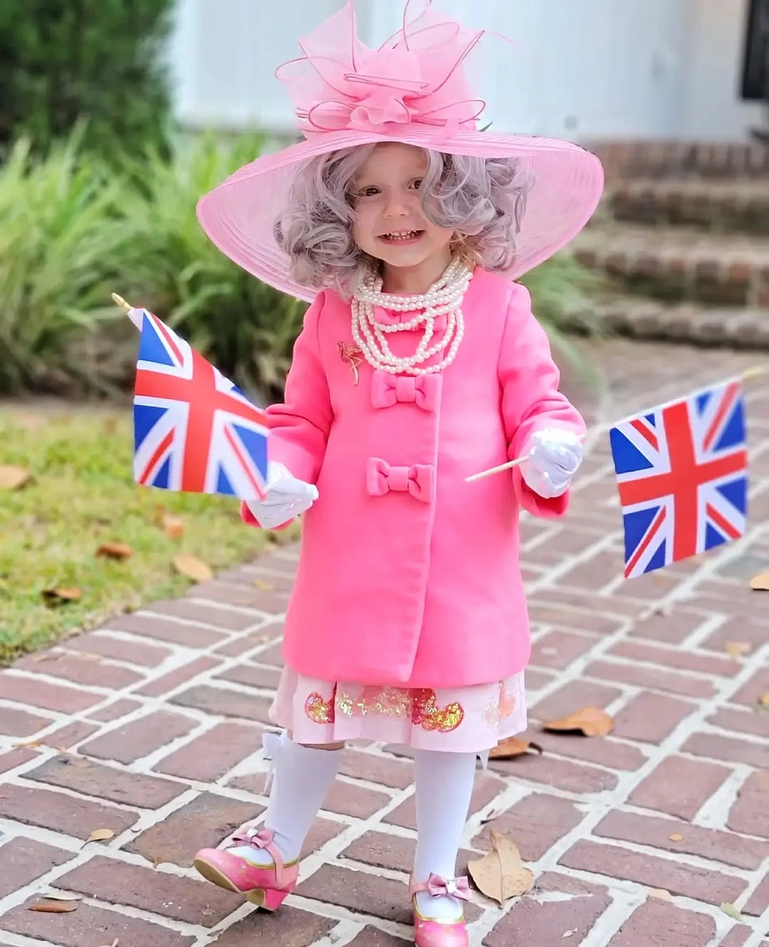 Pale pink coat costume with oversized hat and white tights