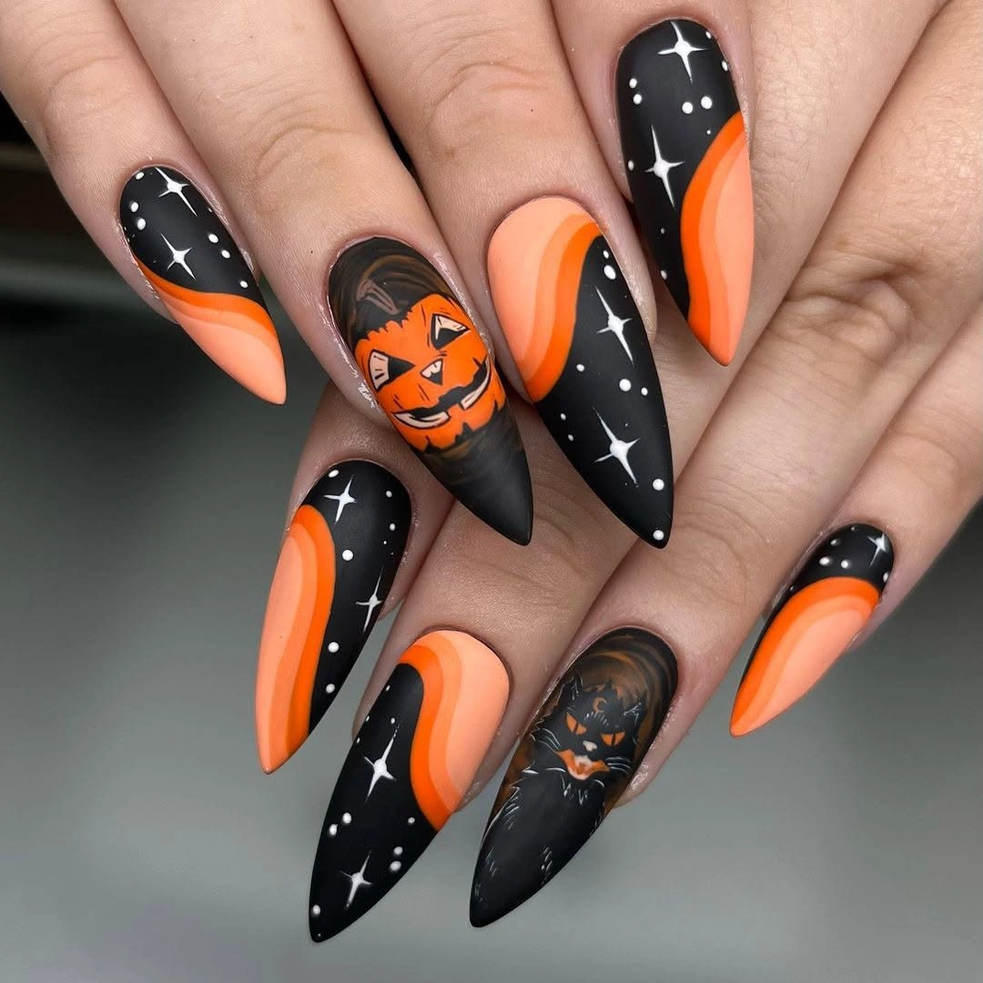 Black orange and white nails with pumpkins and web accents