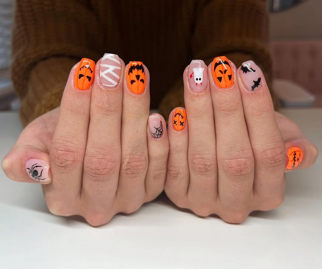 Short mixed orange pink and black pumpkin nails
