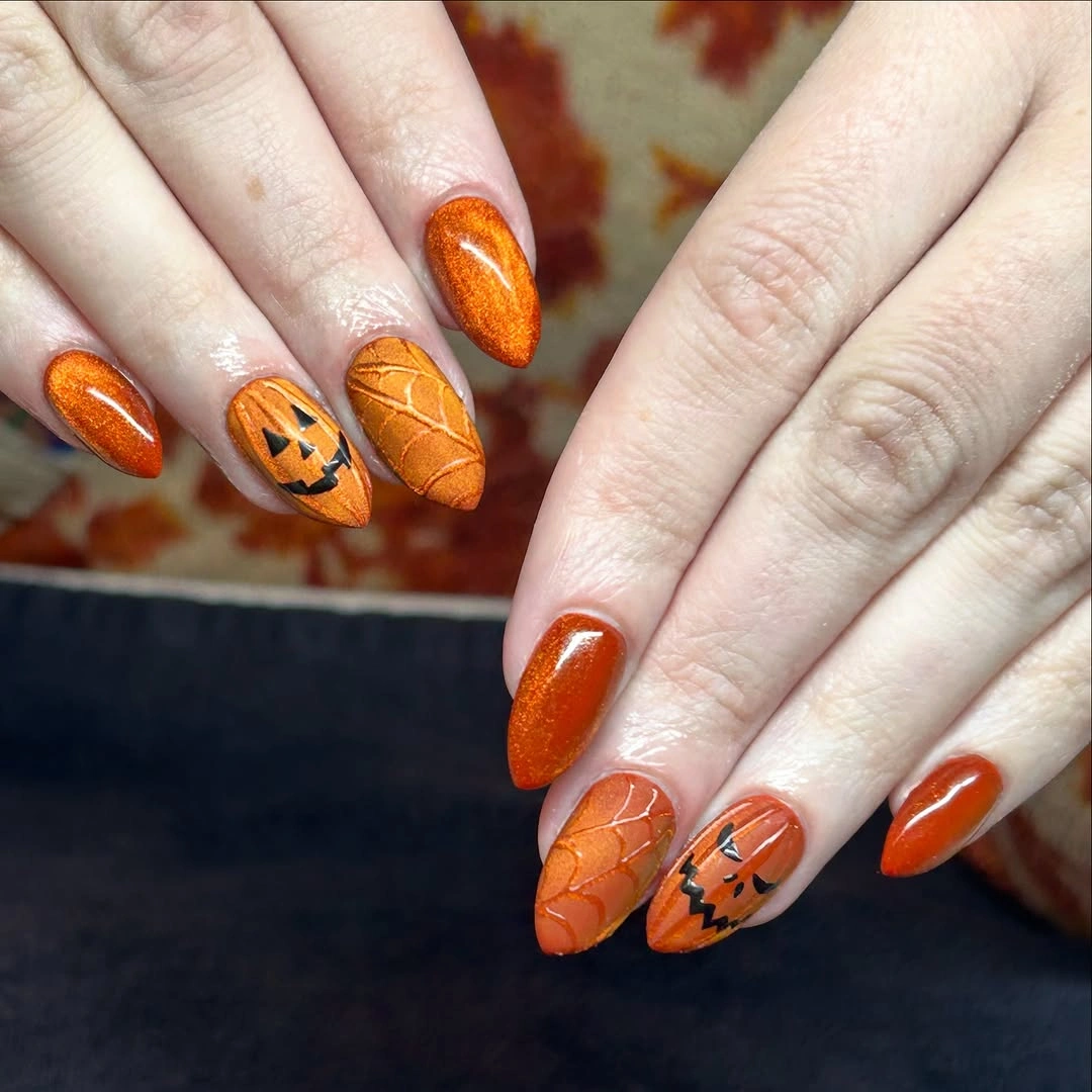 Orange glitter nails with small pumpkin line details