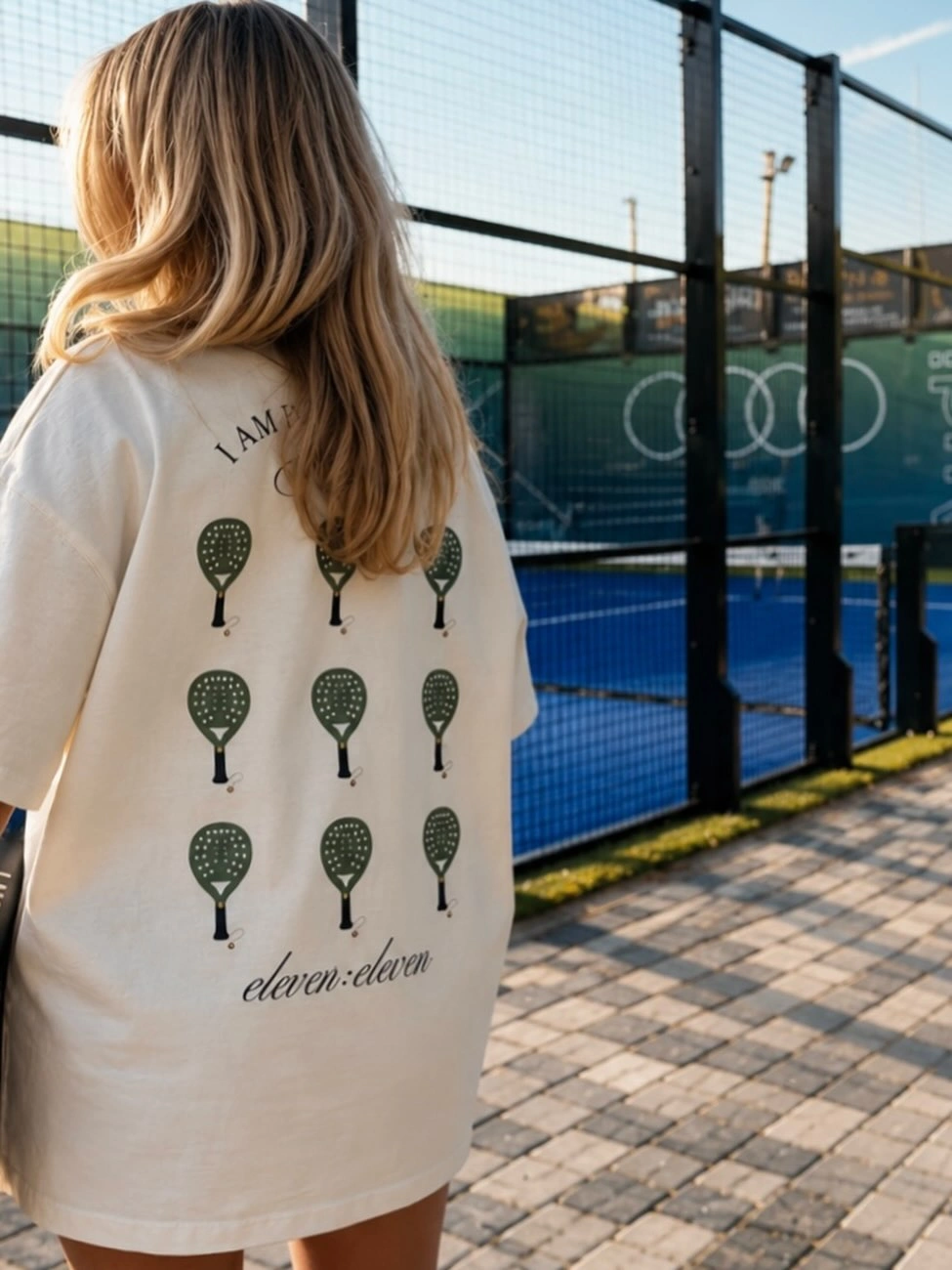 Oversized cream T-shirt with repeated green padel racket print