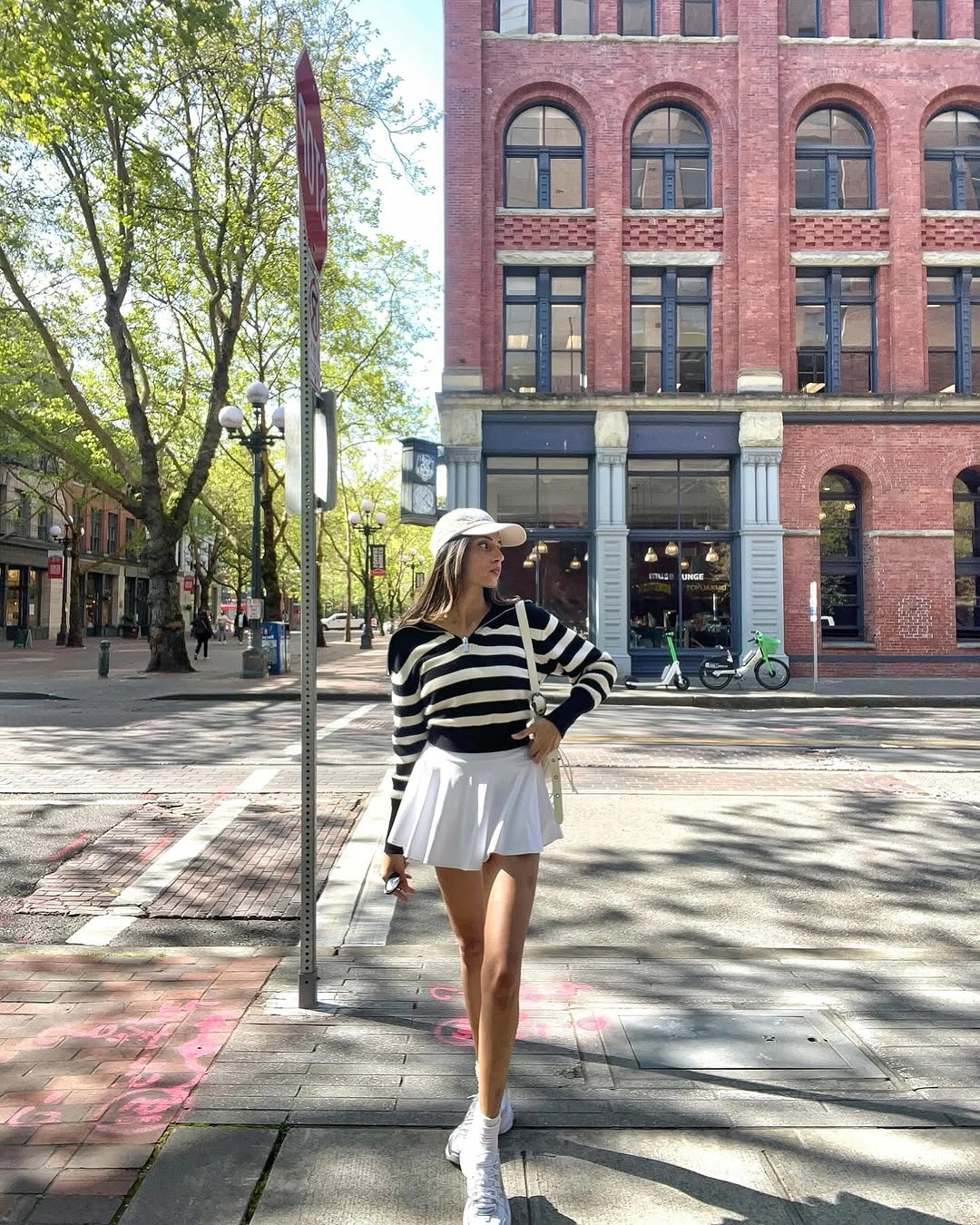 Striped long sleeve top with white pleated skirt and cap