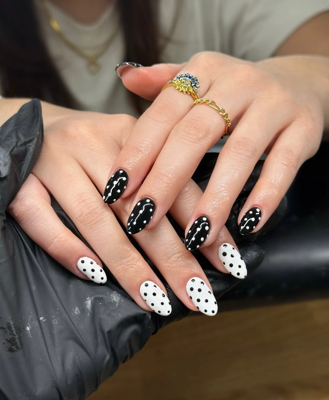 Black and white almond nails with reversed dots and curves