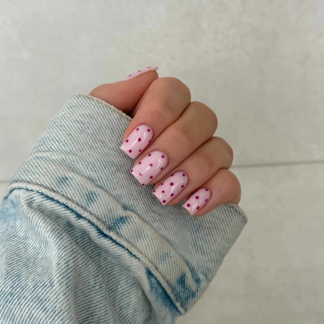Soft square pink nails with orderly berry dots
