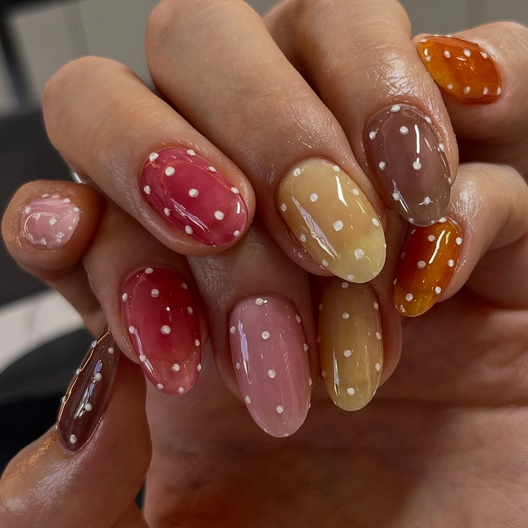 Long multicolor oval nails with repeating white dots