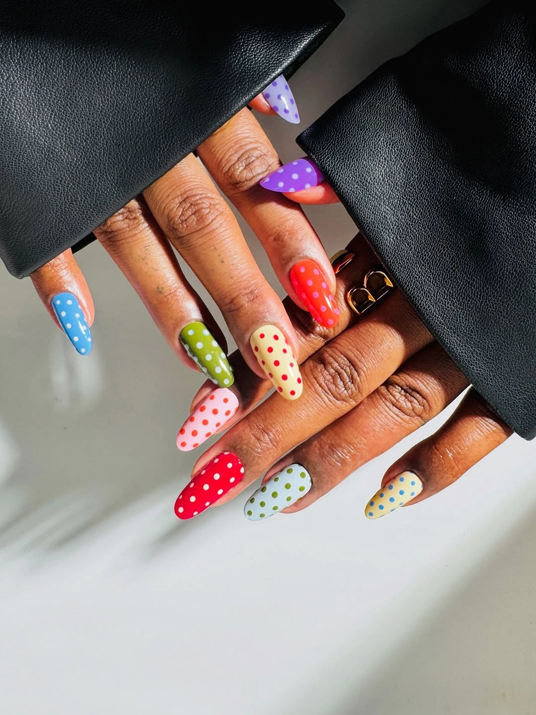 Long rainbow almond nails with contrasting multicolor dots