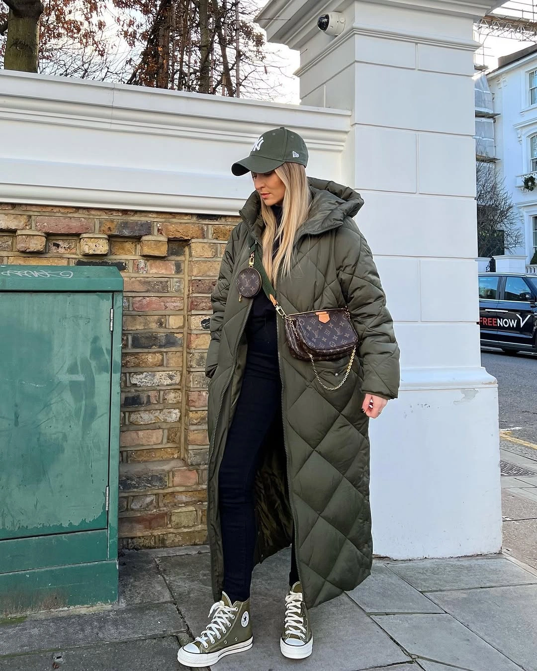 Olive quilted coat with green cap and high-top sneakers