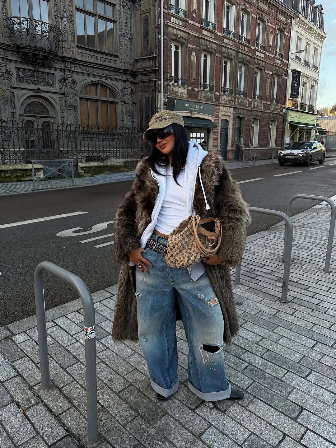 Long brown textured coat with hoodie and wide distressed jeans