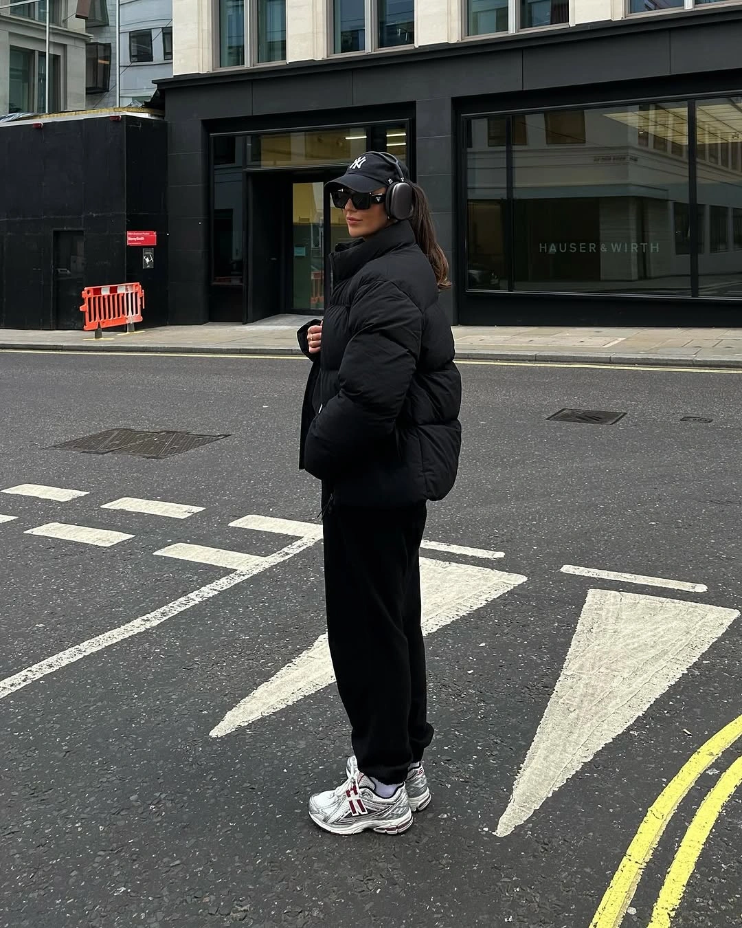 Black puffer with wide trousers and light chunky sneakers