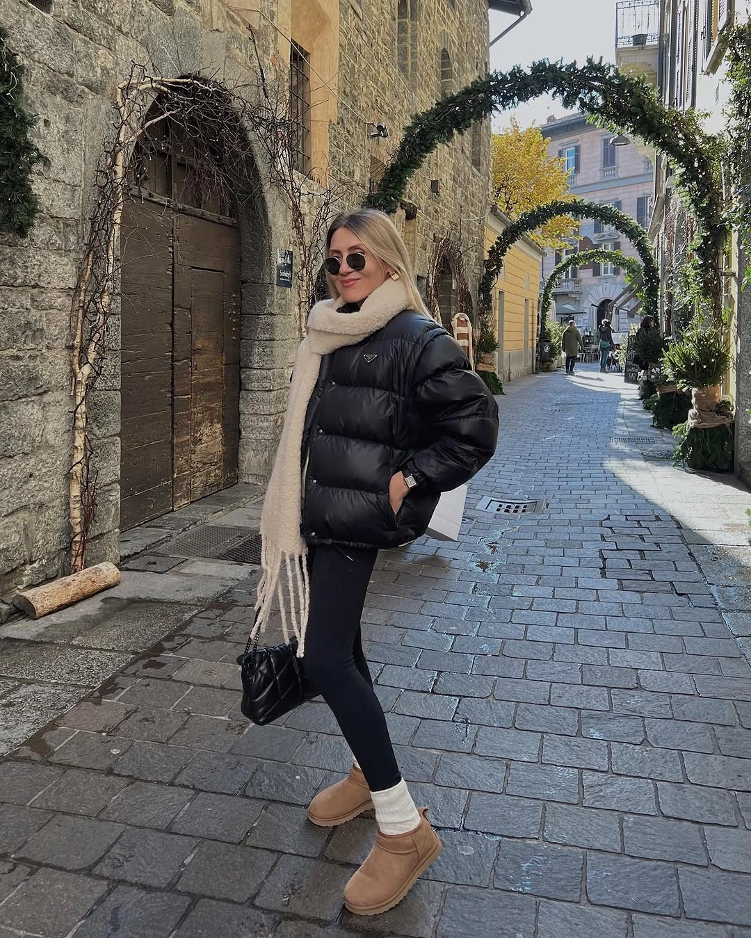 Black puffer with cream scarf and tan boots