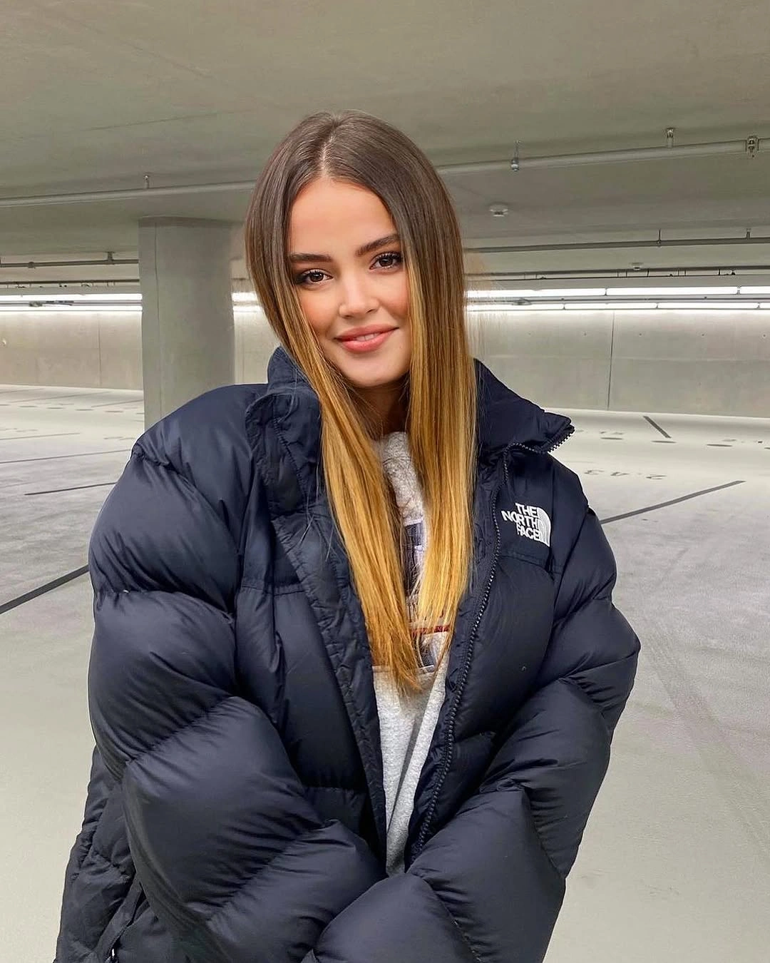 Navy oversized puffer jacket over a gray hoodie