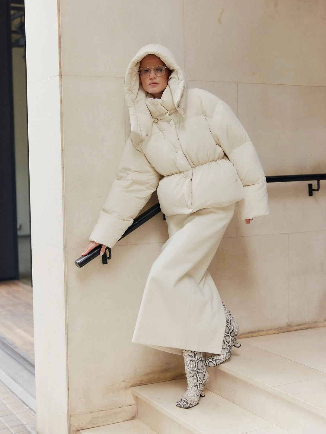 Cream hooded puffer jacket with wide trousers and patterned boots