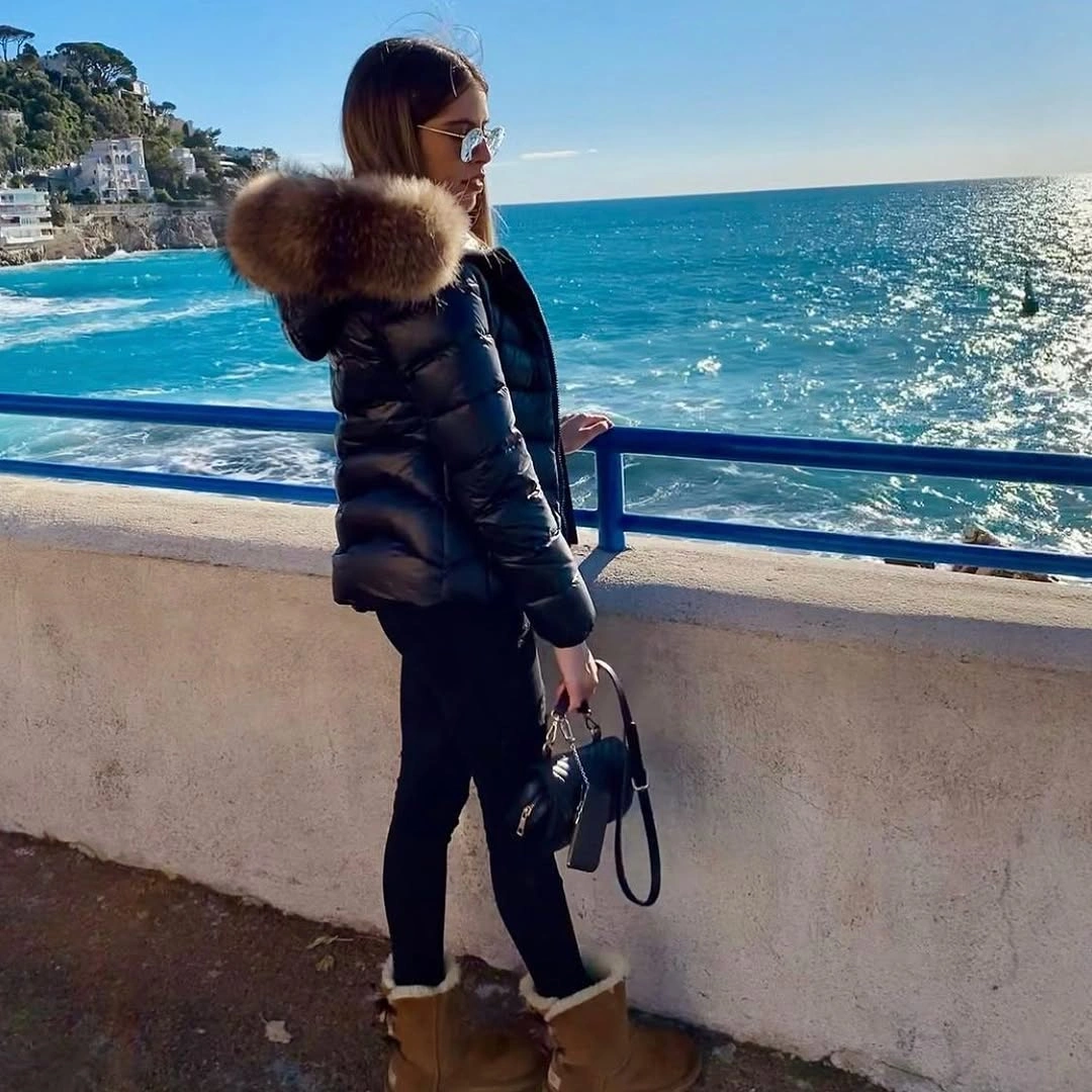 Black puffer jacket with brown fluffy hood trim