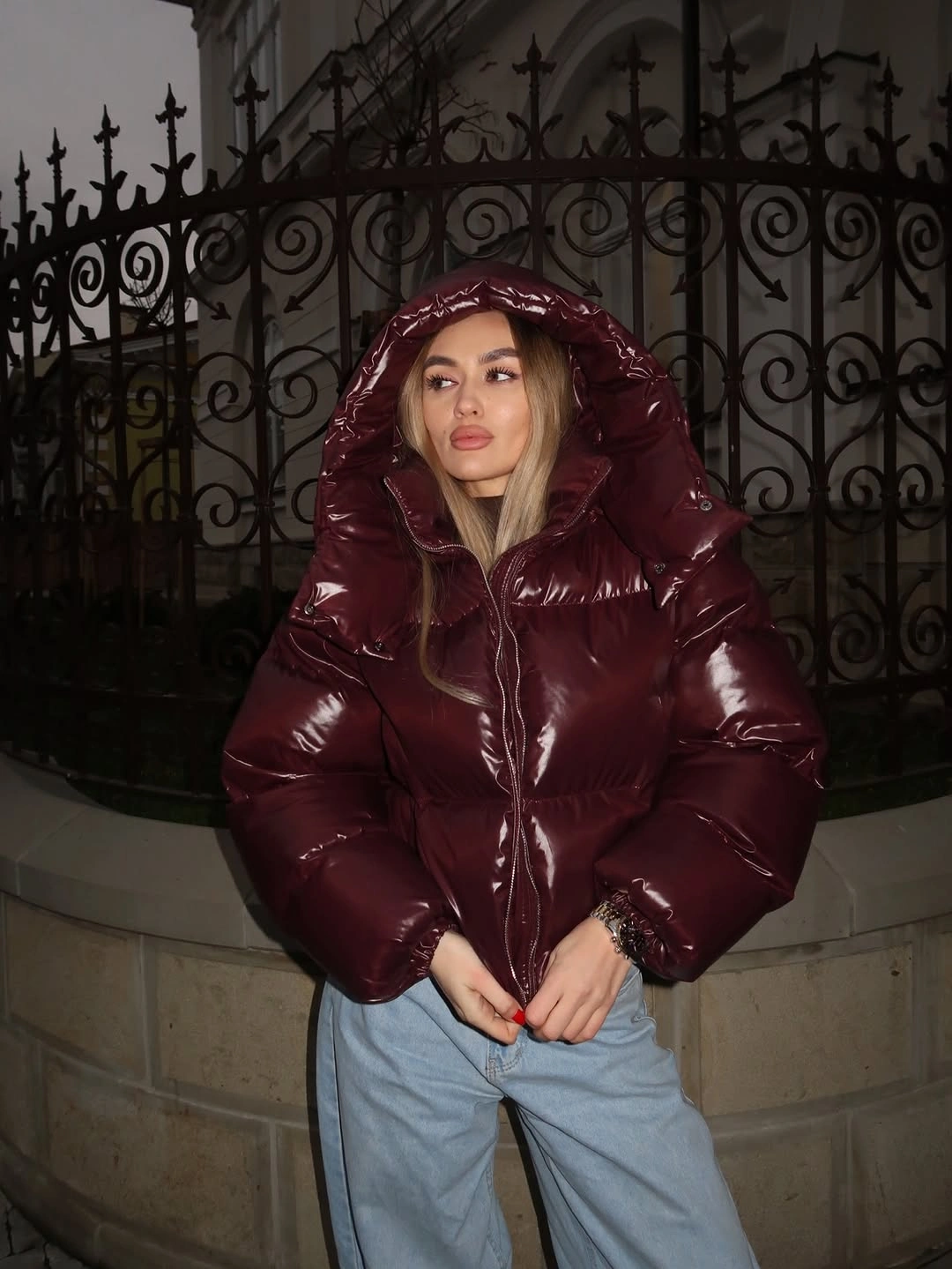 Glossy burgundy hooded puffer with light wide jeans