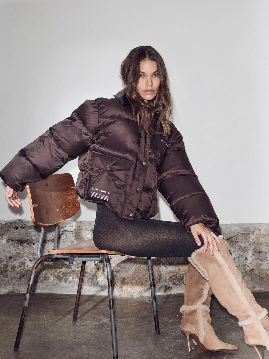 Brown cropped puffer with slim dark layer and plush boots