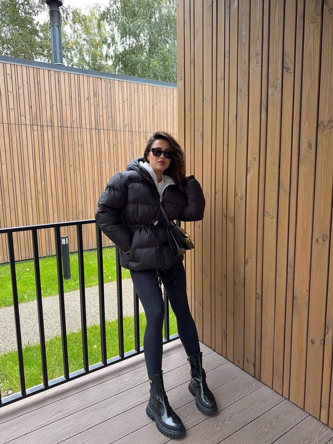 Black hooded puffer with leggings, boots and white layer