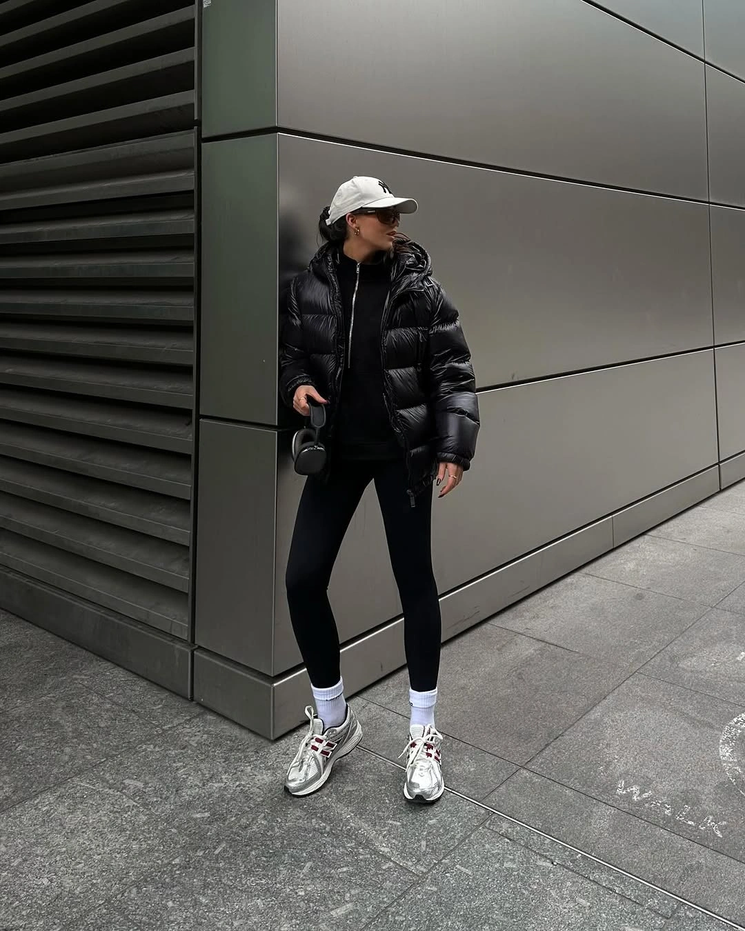 Glossy black puffer with white cap, leggings and sneakers