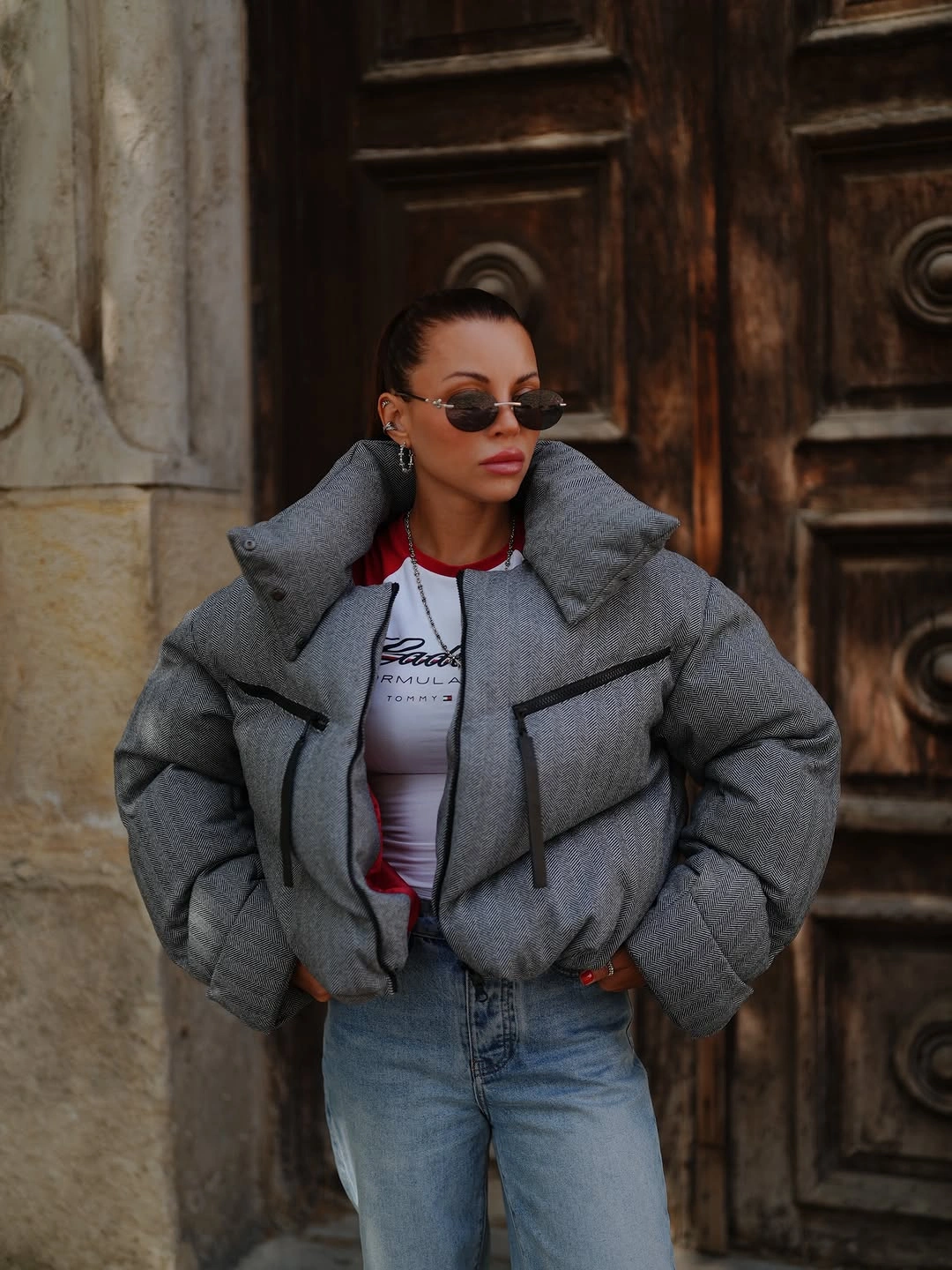 Gray cropped puffer with black trim, red accents and jeans