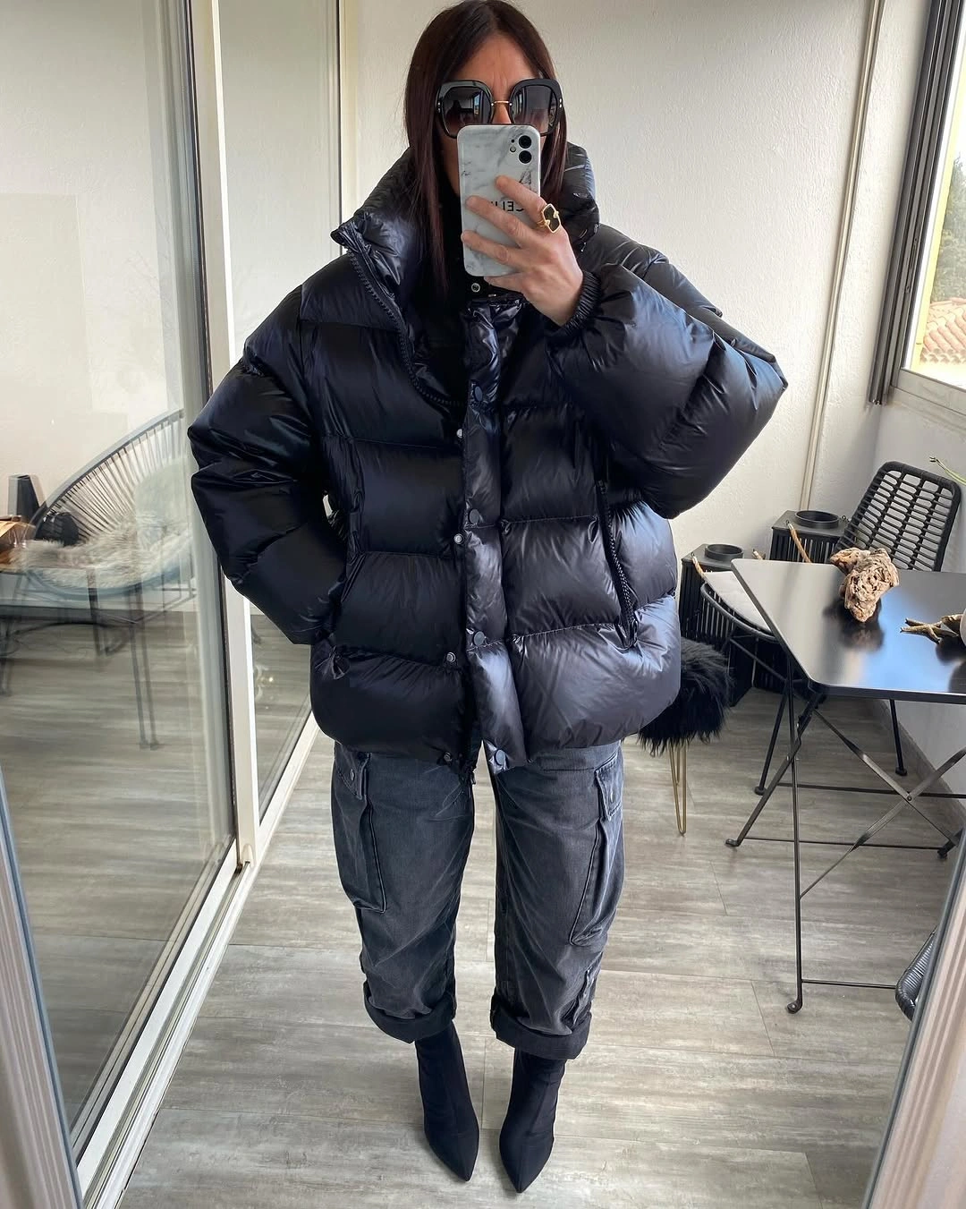 Glossy black puffer with gray cargo pants and pointed boots