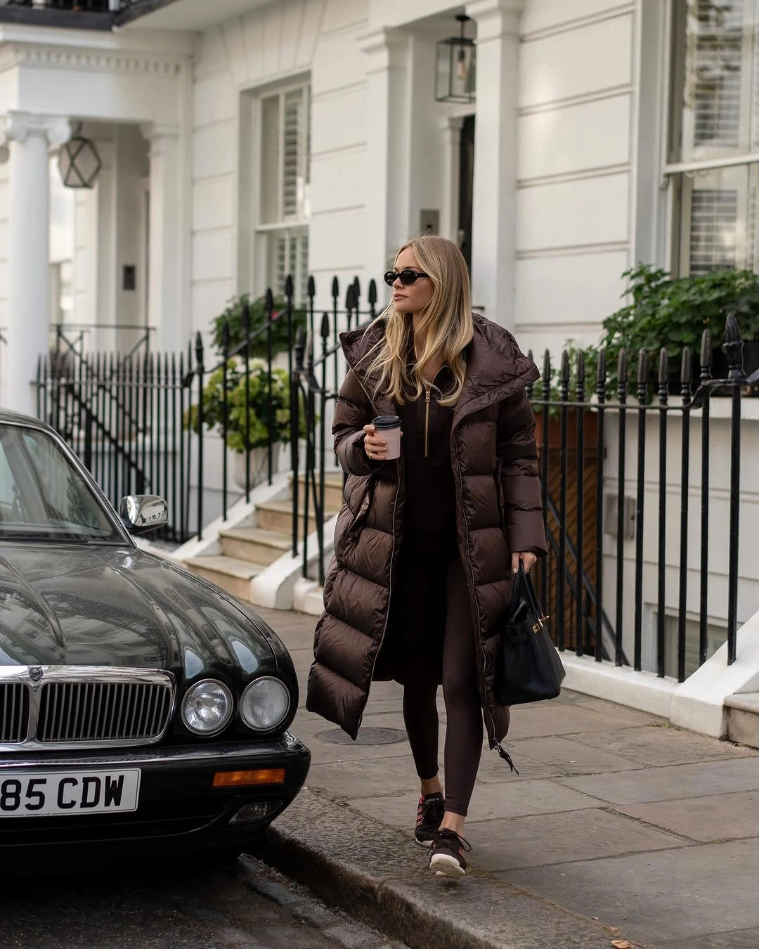 Long brown puffer coat with black base and sneakers