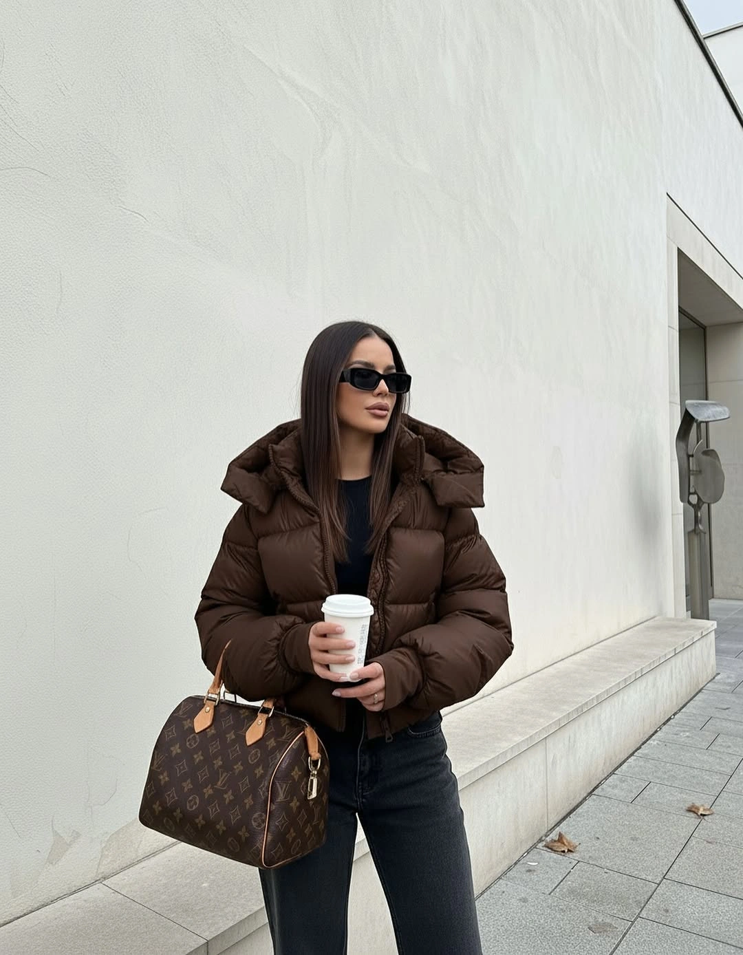 Chocolate cropped puffer with dark jeans and patterned bag