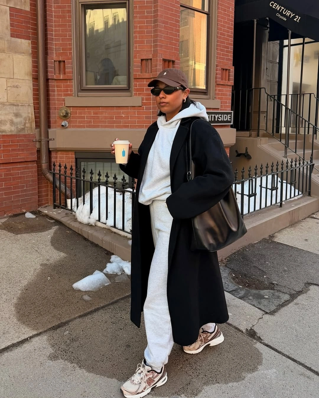 Long black coat with white hoodie, jogger pants and sneakers