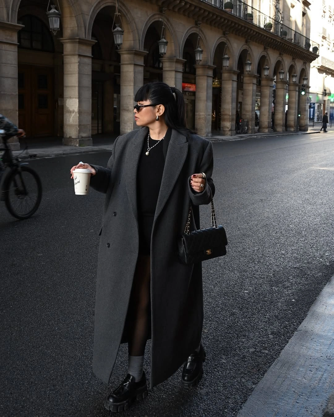 Charcoal coat with dark skirt-like layer and black loafers