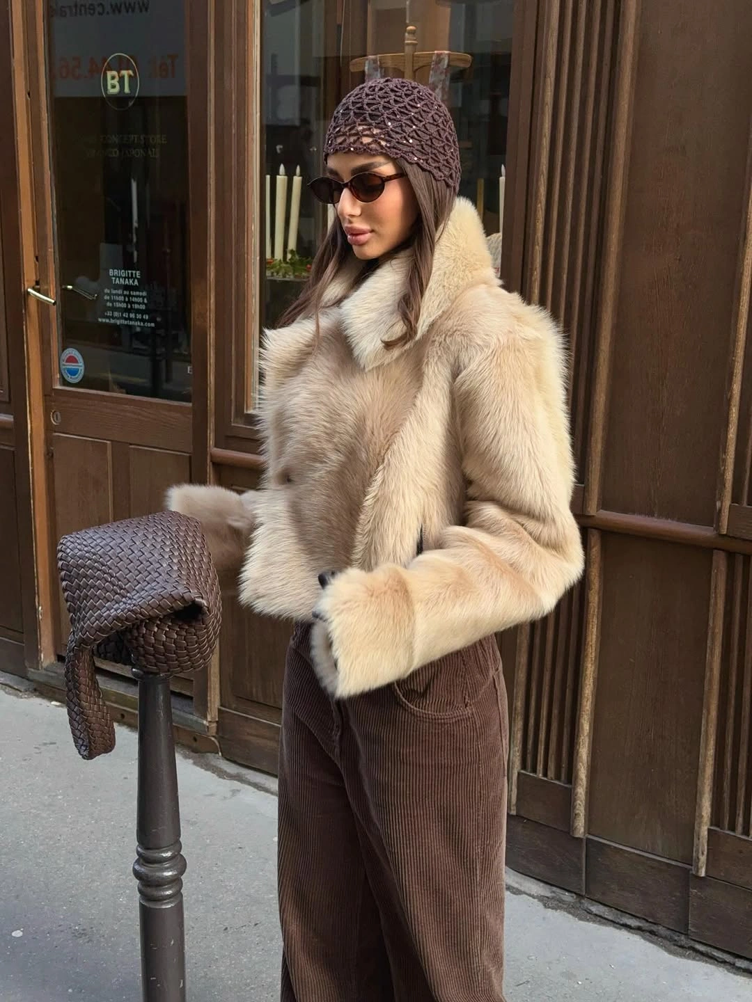 Cream plush jacket with brown trousers and openwork cap