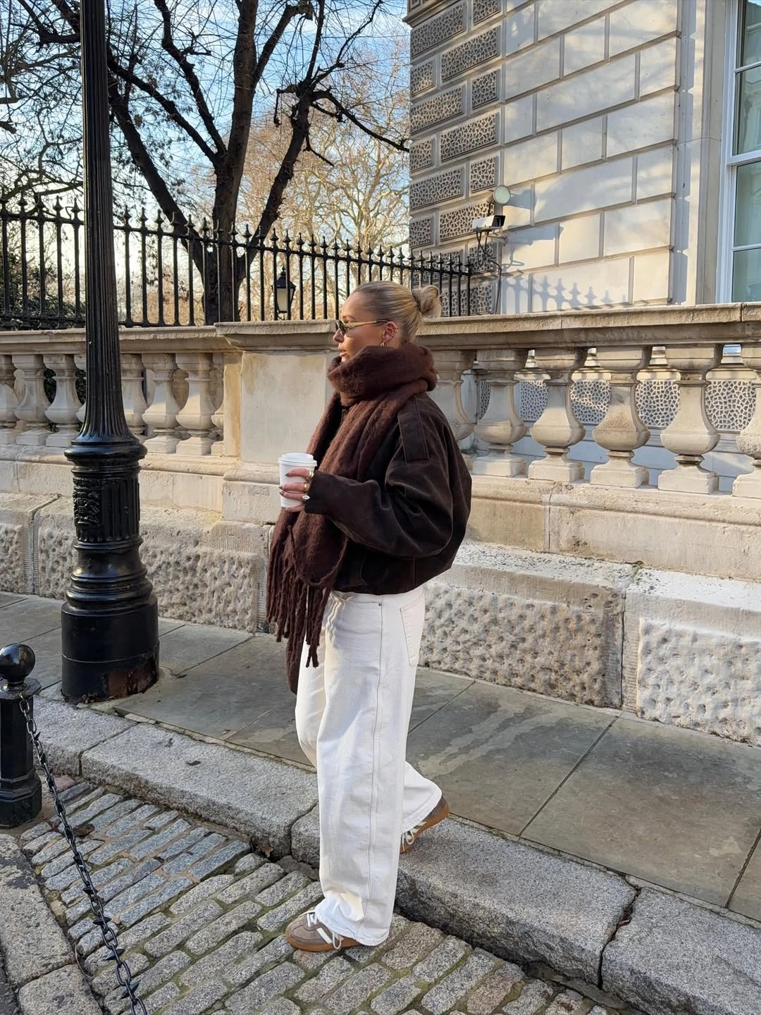 Cropped brown jacket with fringed scarf and white wide pants