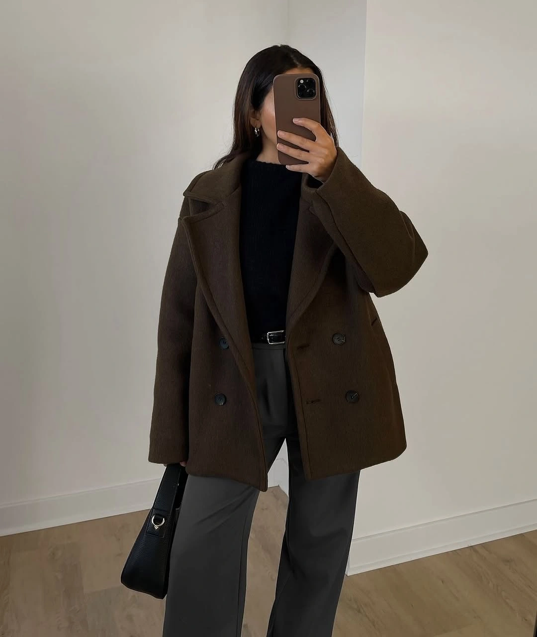 Brown double-breasted coat with black top and gray wide trousers