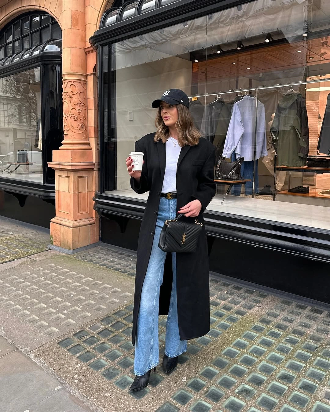 Long black coat with light wide jeans and pointed black shoes